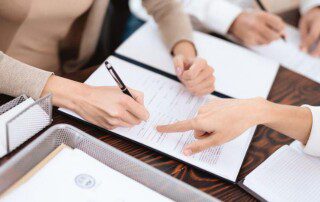 Foreman family law in Bryan, Texas - Image of a couple signing divorce papers